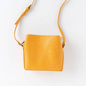 Yellow woman’s purse isolated on white background. top view