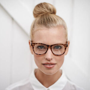 A young woman wearing a blouse and spectacles
