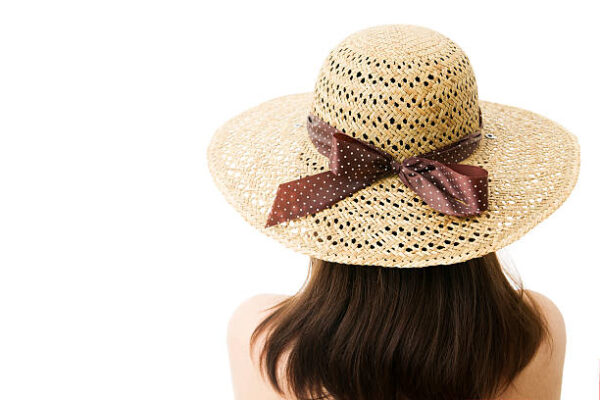 Woman in straw hat isolated on white background. unrecognizable.