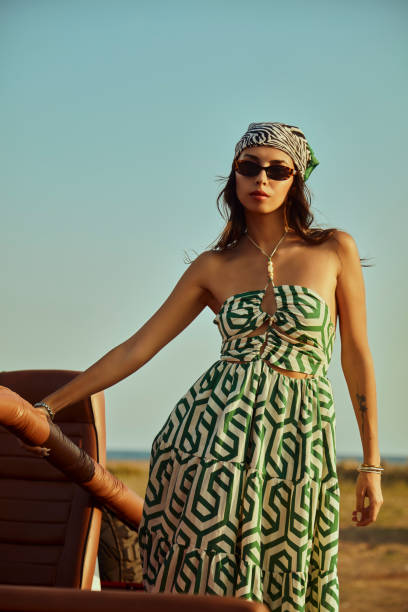 Young woman immersing herself in nature with an open top off road vehicle.